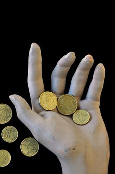 Worn hand holding a few euro money coins. Economic and financial issues concept.
