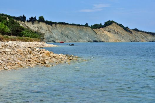 Stone beach seaside and eroded coastal ridges at the island of Zakynthos, Greece.