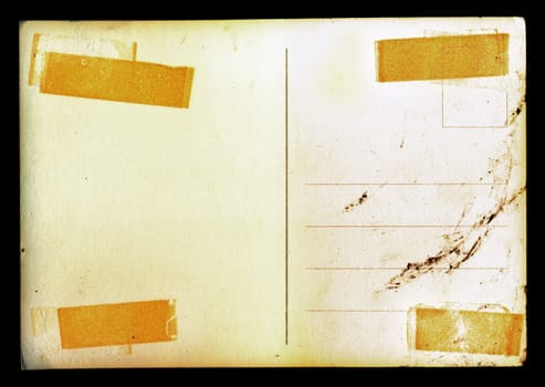 Vintage blank postcard background with adhesive tape stains and ink smudge.