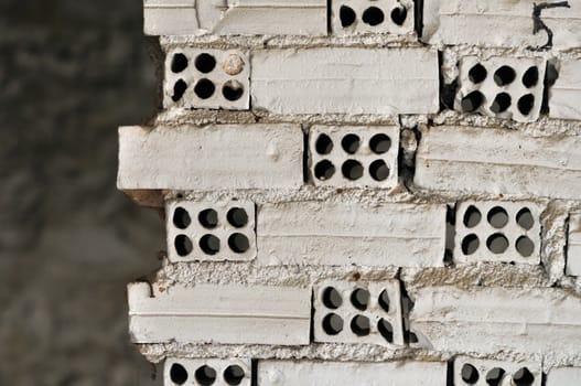 Broken grungy white brick wall background texture.