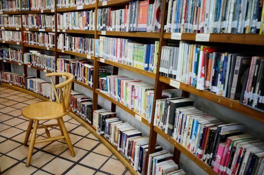 Chair with book shelf in library