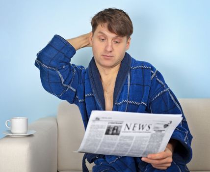 Person reads a newspaper with pensiveness on blue background