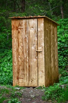 Rustic old wooden toilet in the forest