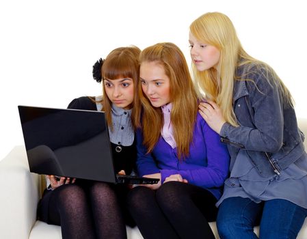 Concerned teenager girls with a black laptop isolated on white background