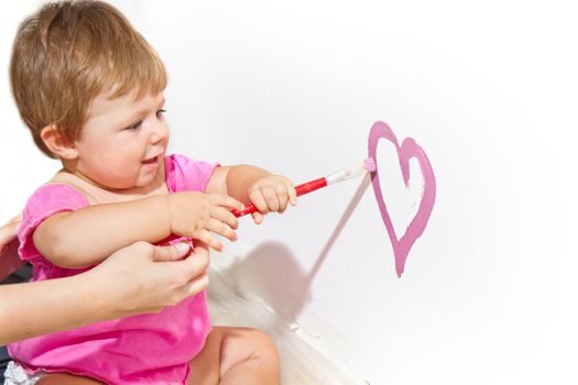 Little girl paint on a board