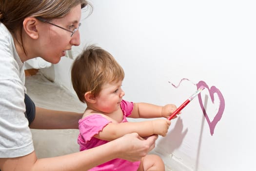 Little girl paint on a board