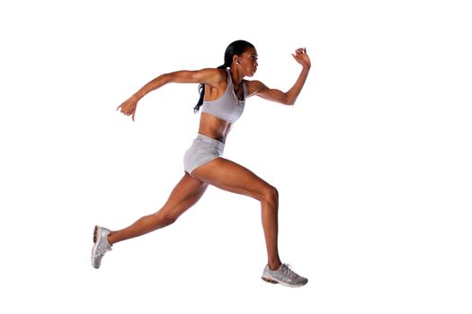 Beautiful fast running female athlete with toned muscular fitness body in grey with headset listening to music while exercising, isolated.