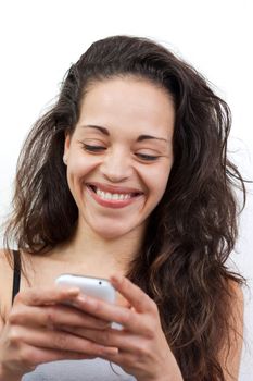 Happy woman writing a message on her telephone