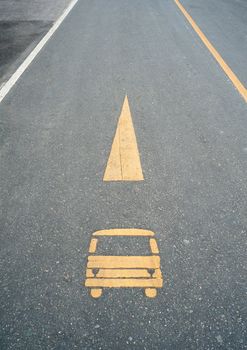 Grunge car sign on street with white and yellow line