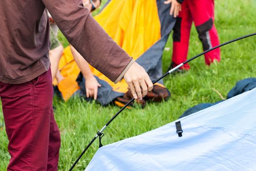 Putting up tent in a camping