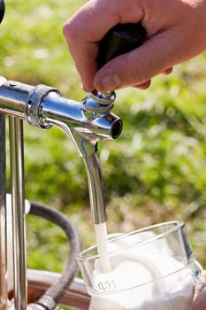 Man filling a glass of beer