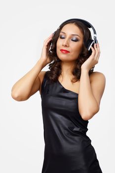 Portrait of young woman with headphones in studio