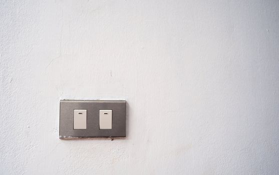 Old power switch on white wall texture