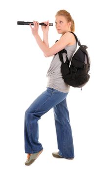 Attractive standing young woman with rucksack is looking through telescope. on white background