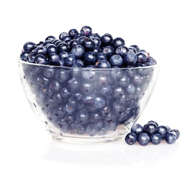 Blueberries in transparent glass dish with soft shadow on white background