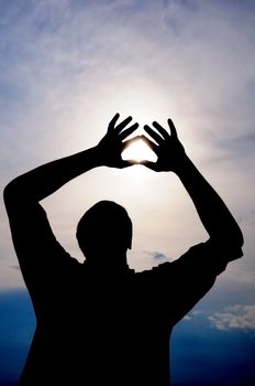 Male is holding the sun in his hands with heart symbol