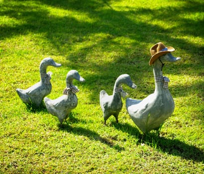 Duck sculpture on green field for decorate garden