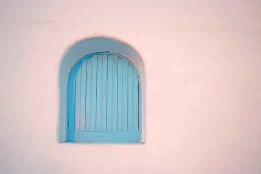 Vintage arch blue windows on the white wall.
