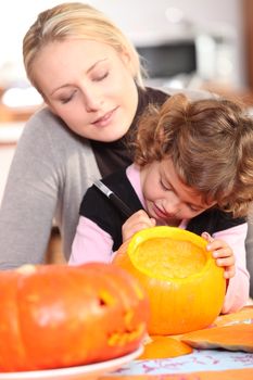 girl painting pumpkin
