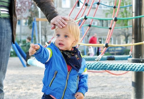 two years old blonde blue eyes beautiful kid pointing with the finger