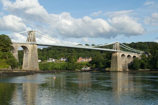 A view of the historic Menai suspension bridge spanning the Menai Straits, Gwynnedd, Wales, UK.