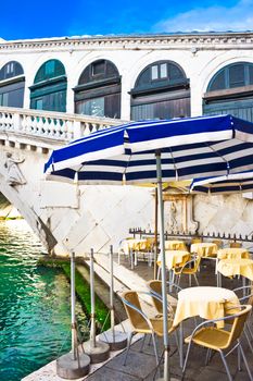 Restaurant on the bank of Grand Canal near Bridge Rialto, Venice, Italy