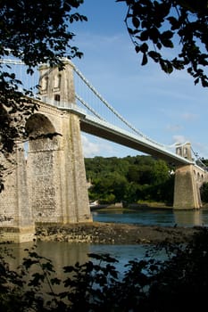 A view of the historic Menai suspension bridge spanning the Menai Straits, Gwynnedd, Wales, UK.