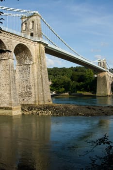 A view of the historic Menai suspension bridge spanning the Menai Straits, Gwynnedd, Wales, UK.