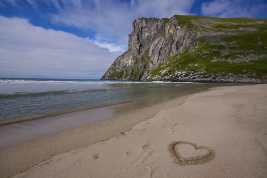 Symbo lof love in the sand on a picturesque beach on Lofoten islands