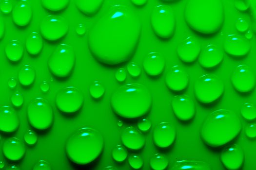 Water drops on a green surface