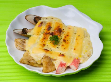 seafood baked with cheese, seafood gratin on background