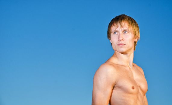 Portrait of handsome man on sky background