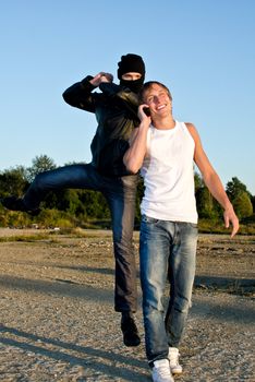 Bandit in mask trying to rob young man