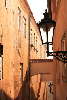 Closeup of vintage street lamp on background with nice old alley at sunrise