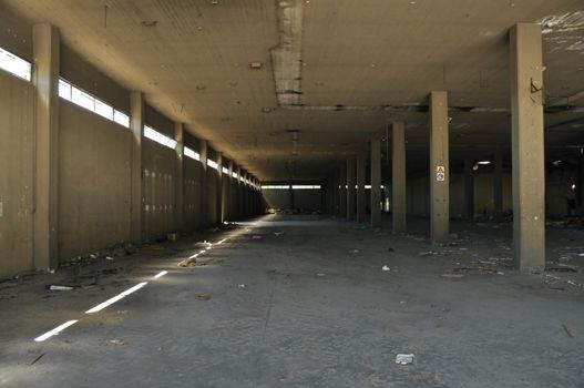 Dirty floor concrete wall and ceiling in abandoned factory. Industrial architecture.