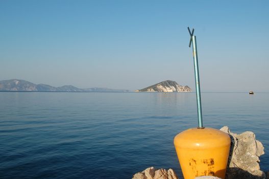 Marathonisi islet as seen from a pier on Keri Beach in the bay of Laganas. Zakynthos, Greece.