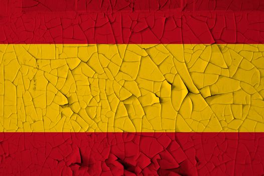 Spanish national flag on peeling paint wall. Weathered grunge background.