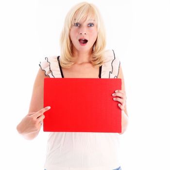 Beautiful blonde woman pointing to a blank red board for your text that she is holding in front of her with a look of amazement on her face isolated on white Beautiful blonde woman pointing to a blank red board thant she is holding in front of her with a look of amazement on her face isolated on white 