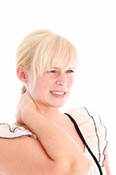 Woman grimacing in pain as she stands rubbing her stiff neck to relieve the tension 