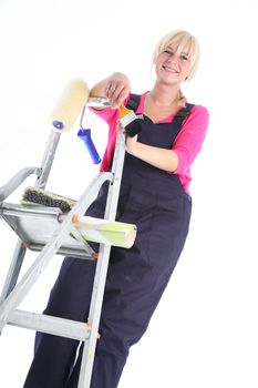 Female house painter posing on ladders - isolated o white 
