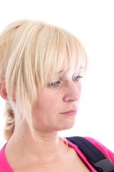 Studio portrait isolated on white of a sad despondent beautiful blonde woman with downcast eyes 