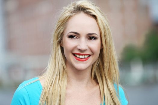 Portrait of smiling young woman under natural light 