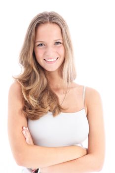 Sociable young girl with lovely smile standing facing the camera with her arms folded isolated on white 