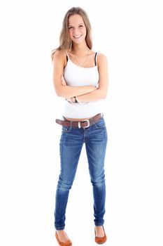 Full length portrait of a slender happy teenager standing with her arms folded isolated on a white background 