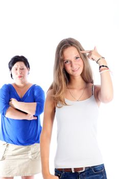 Defiant teenager giving a victory sign over her shoulder in the direction of her frustrated angry mother with whom she has been arguing Defiant teenager giving victory sign over her shoulder in the direction of her frustrated angry mother with whom she has been arguing