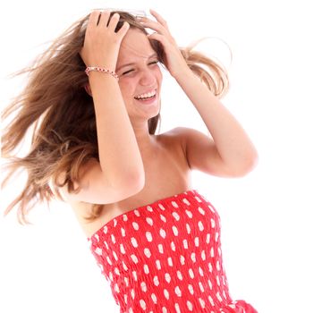 Attractive young teenage girl having a good time laughing with her long blonde hair blowing around her face 