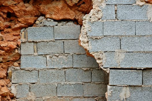 Broken stone and cinder block brick walls background texture.