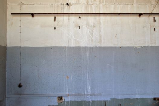 Weathered wall in abandoned industrial interior. Background texture.