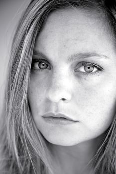 Woman blonde with freckles serious and sad
