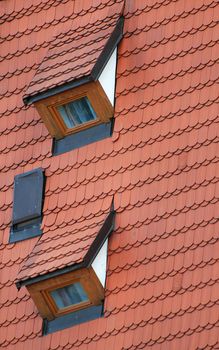 Red roof covered by tiles and two dormers